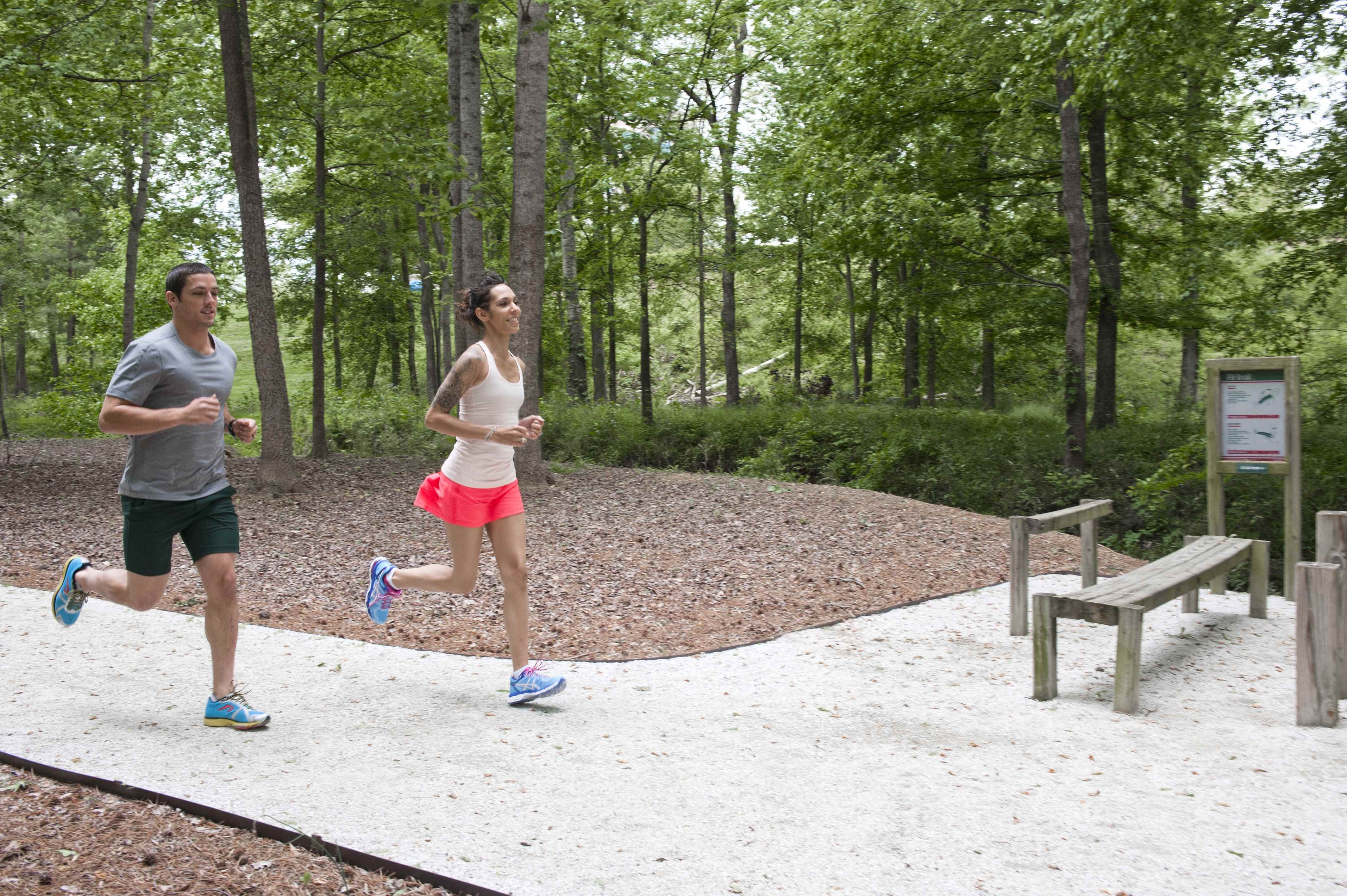 Two adults running on Fit Trail in Ballantyne Campus3