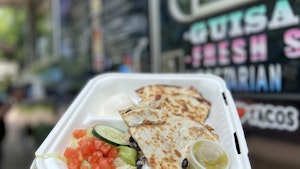 Quesadilla in a to-go box in front of taco food truck2