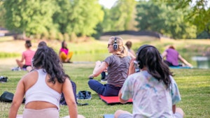 Adults sitting outdoors at yoga class in Ballantyne1