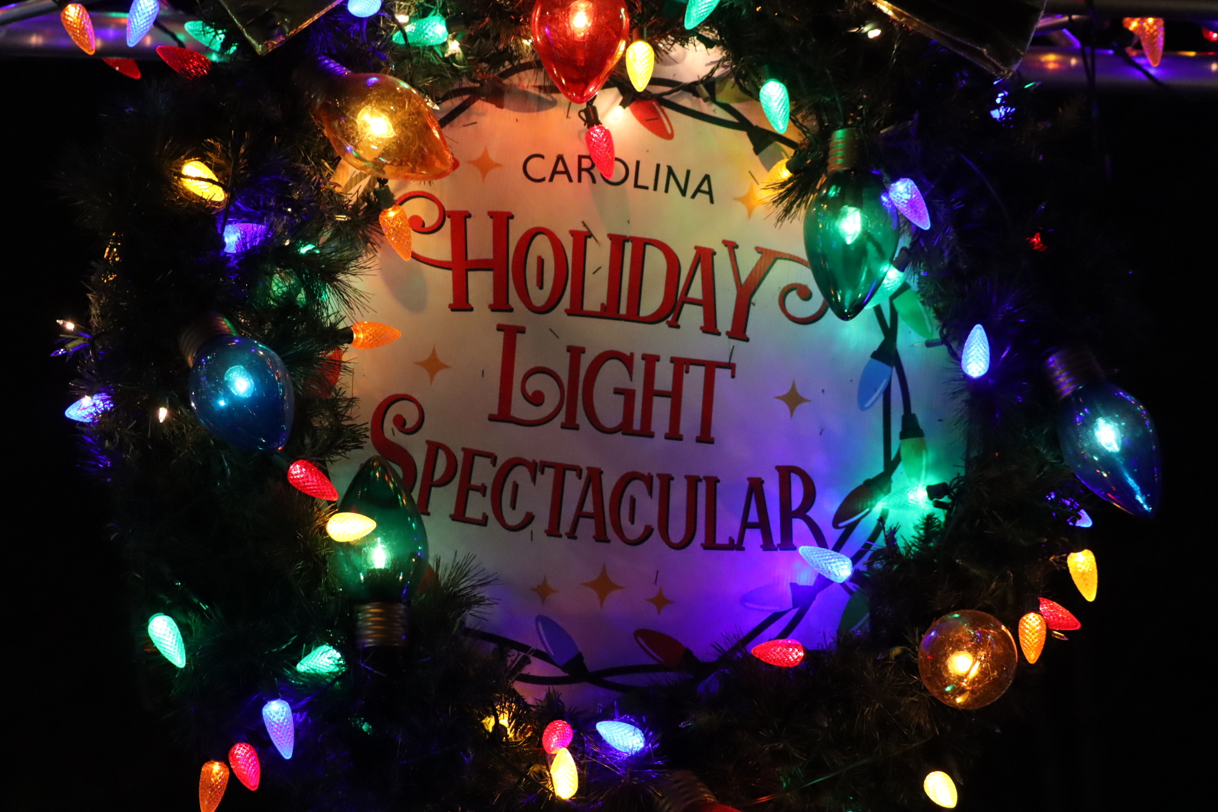 A sign with the logo for the Carolina Holiday Light Spectacular event1