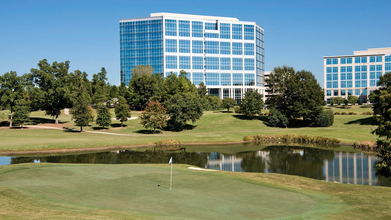 Greens and pond with Brigham and Calhoun Building on Ballantyne Campus3