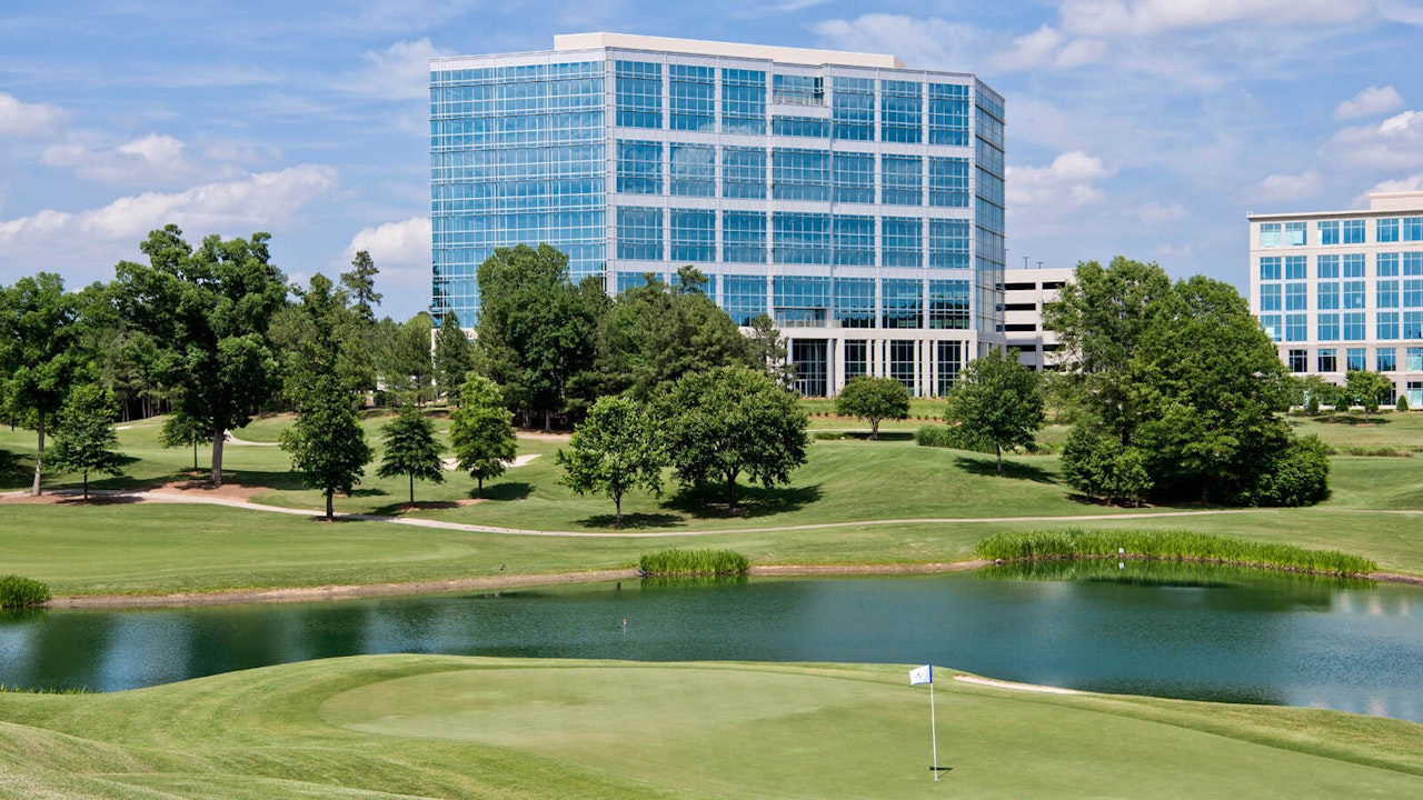 Pond and greens and Brigham Building on Ballantyne Campus1
