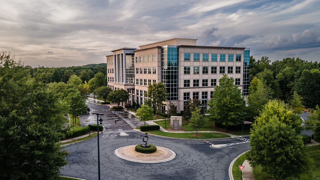 Drone view dusk of roundabout and Crawford Building exterior on Ballantyne Campus2