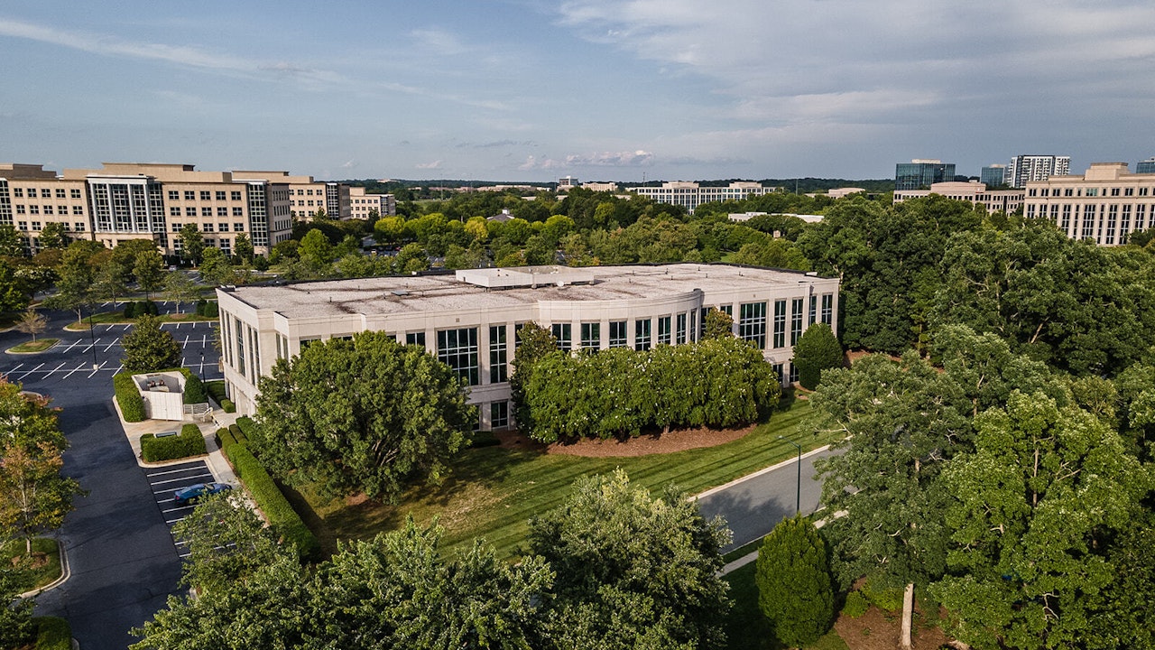 Drone view of trees and Curran Building exterior on Ballantyne Campus4