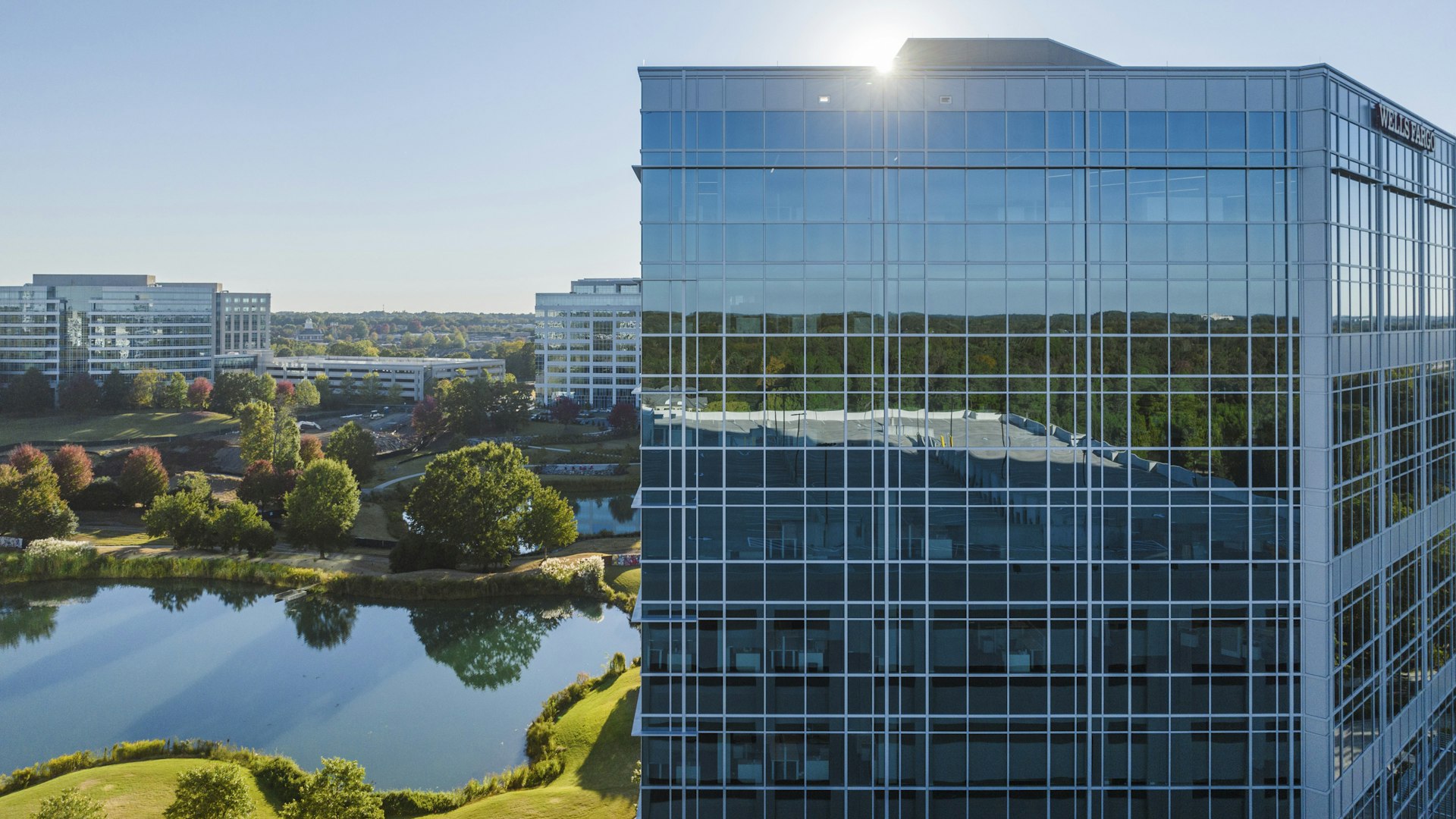 An aerial view of an office building and the surrounding greenspace at the Ballantyne campus.